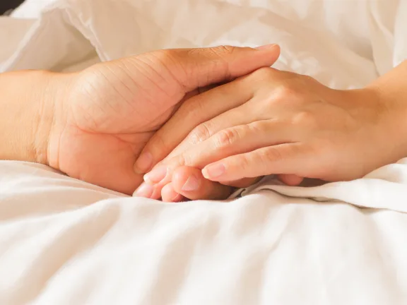 Händer som håller om varandra i livets slutskede.