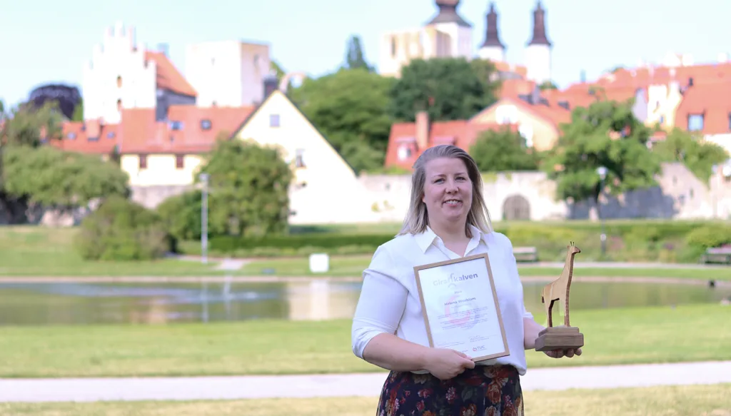 Helena Woxblom stor i Almedalen med Diplomet och statyetten Giraffkalven efter att ha vunnit priset Giraffkalven för sitt examensarbete.